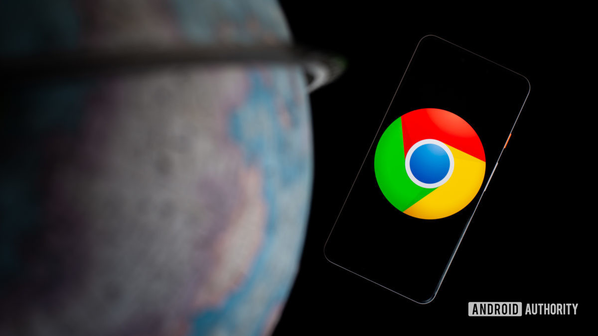 Google Chrome on smartphone next to globe stock photo
