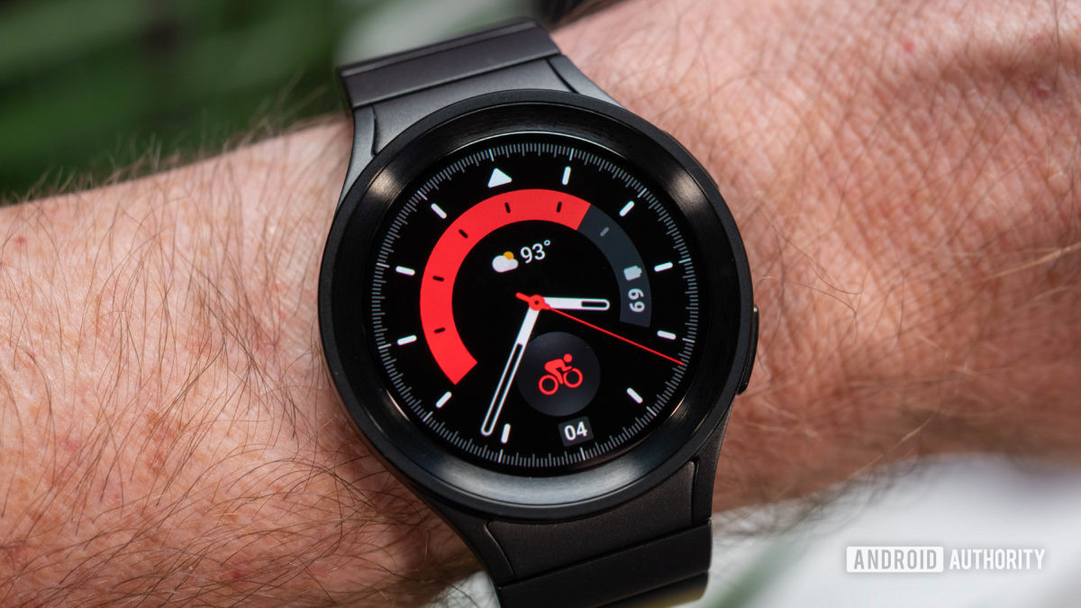 Samsung Galaxy Watch 5 Pro in black titanium color metal strap on wrist showing red watch face